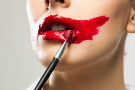 close-up of a female vivid red mouth, lipstick red paintの写真素材