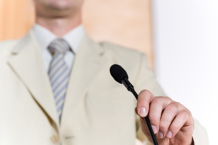 image of a man s hand holding a microphoneの写真素材