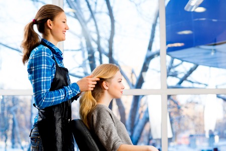 young attractive woman hairdresser hairstyle customer picksの写真素材