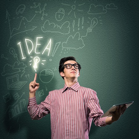 young man holding a tablet, hand up - the ideaの写真素材