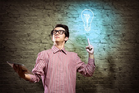 young man holding a tablet, hand up - the ideaの写真素材