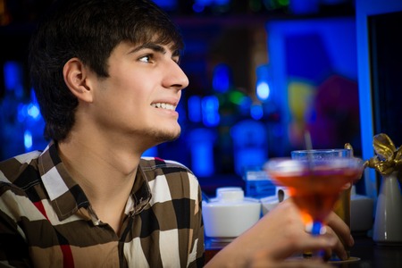 portrait of a young man at the bar, fun nightlifeの写真素材