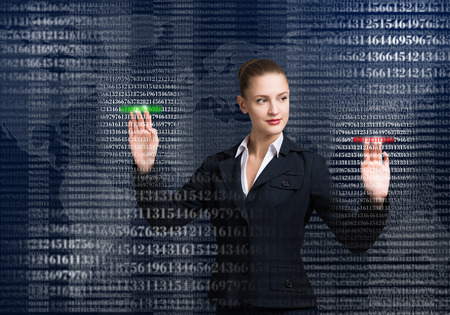 Young businesswoman touching icon of media screenの写真素材