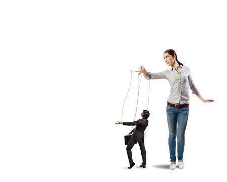 puppeteer controls a businessman holding his strings, the concept of control of businessの写真素材