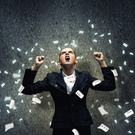 Young businesswoman in rage screaming up furiouslyの写真素材