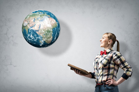 Young woman in casual with book in hands  Elements of this image are furnished by NASAの写真素材