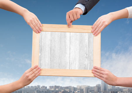 Close up of human hands holding wooden frameの写真素材