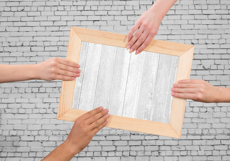 Close up of human hands holding wooden frameの写真素材