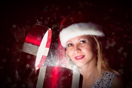 woman opens a box of magic, sorcery, and there shines the light, Christmas miracleの写真素材