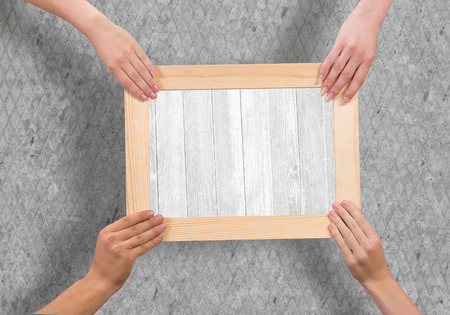 Close up of human hands holding wooden frameの写真素材
