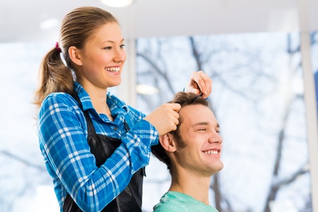young attractive woman hairdresser hairstyle customer picksの写真素材