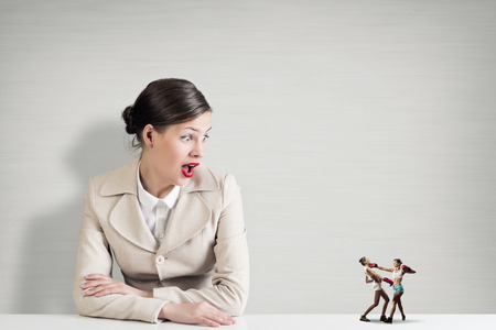 Attractive businesswoman and miniatures of two boxing womenの写真素材