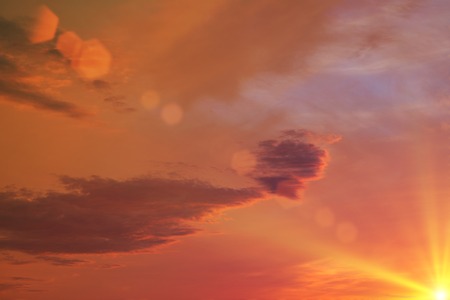 setting sun paints the evening sky in shades of yellowの写真素材