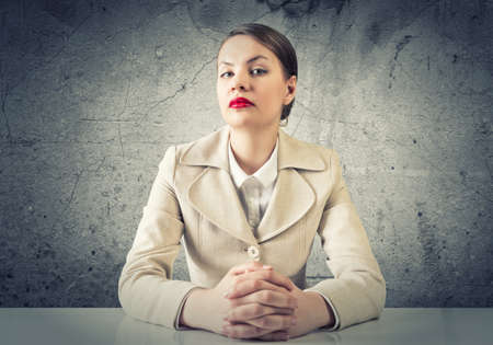 Portrait of young elegant businesswoman sitting at tableの写真素材