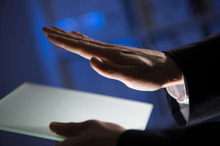 Close up of businessman hand touching Tablet screen