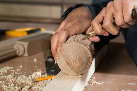 Close up carpenter\'s hands that work with cutter