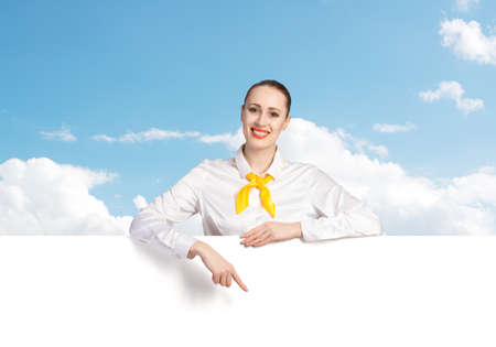 Young pretty woman with white blank bannerの写真素材