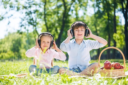 Little cute boy and girl in summer parkの写真素材