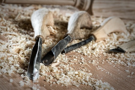 Close up of cutters for wood lying among sawdustの写真素材