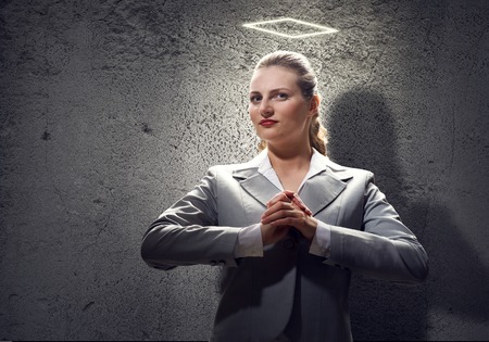 Young saint businesswoman with halo above headの写真素材