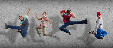 Group of dancer in jump on cement background