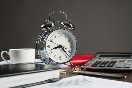 Close up of calculator documents and other staff on office tableの写真素材