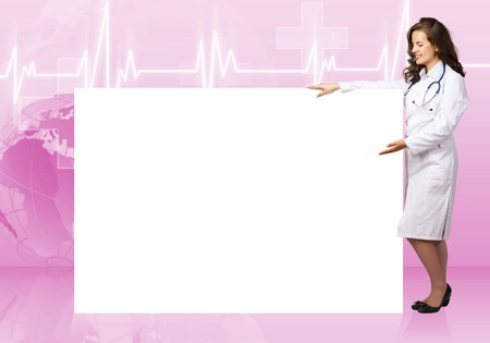 Young pretty woman doctor with white blank bannerの写真素材