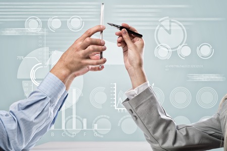 Close up of business people hands using mobile phoneの写真素材