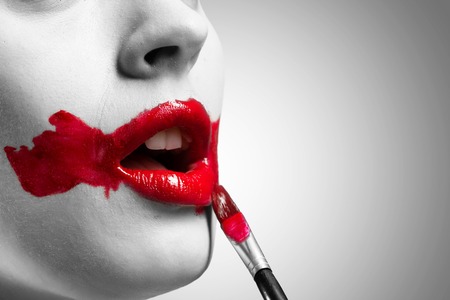 close-up of a female vivid red mouth, conceptual black and white imageの写真素材