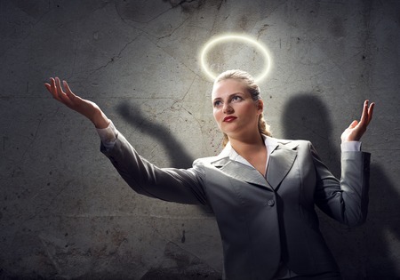 Young saint businesswoman with halo above headの写真素材