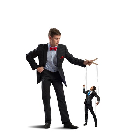 puppeteer holds the puppet business man on the ropesの写真素材