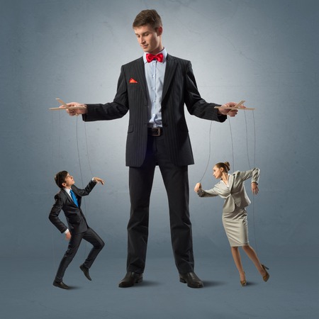 puppeteer keeps business people puppets, concept control businessの写真素材