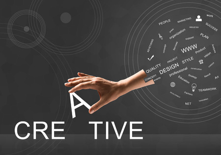 Human hand connecting letters of word creativeの写真素材
