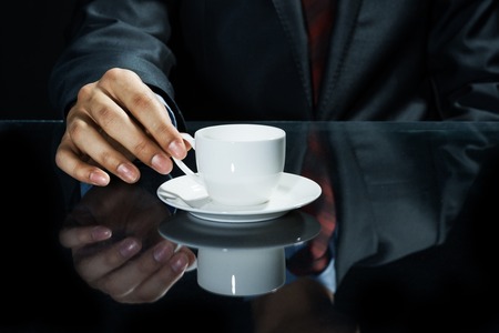 Close up of businessman hand having a cup of coffeeの写真素材