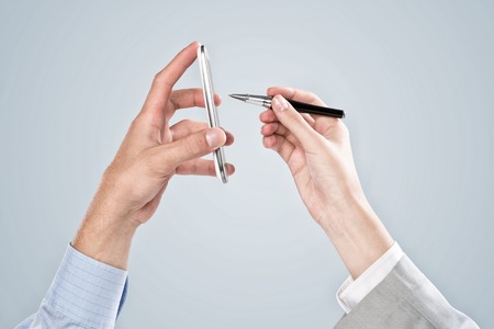 Close up of business people hands using mobile phoneの写真素材