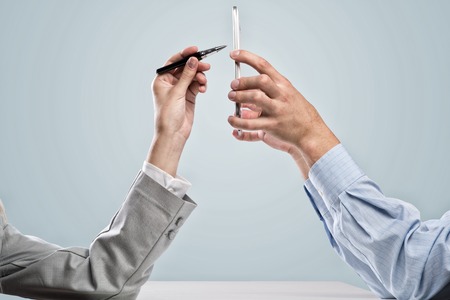 Close up of business people hands using mobile phoneの写真素材