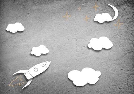 Background image with flying drawn rocket on cement wallの写真素材