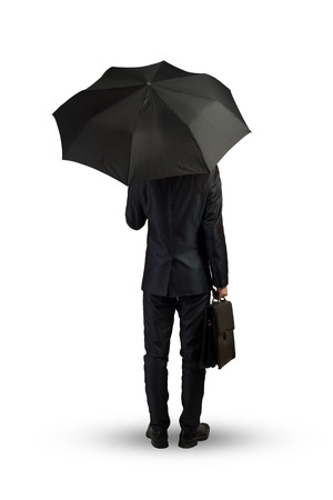 Rear view of businessman with umbrella isolated on white backgroundの写真素材