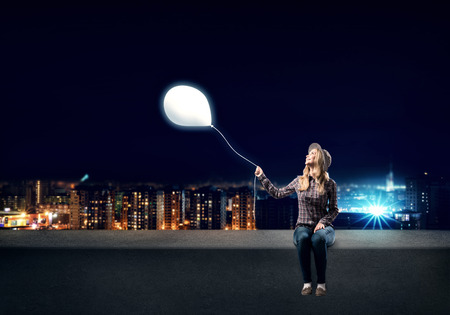 Young woman in casual holding balloon. Idea conceptの写真素材