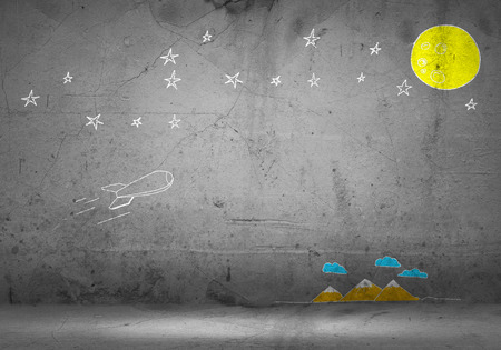 Background image with flying drawn rocket on cement wallの写真素材
