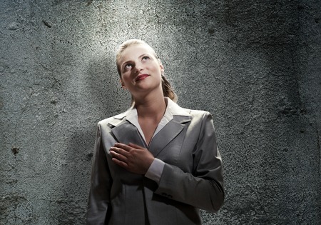 Young saint businesswoman with light above her headの写真素材
