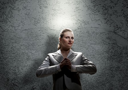 Young saint businesswoman with light above her headの写真素材