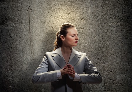 Young saint businesswoman with light above her headの写真素材