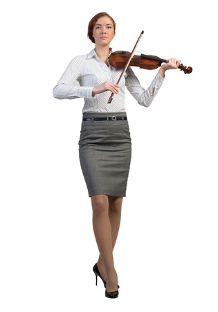 Young pretty businesswoman playing violin isolated on whiteの写真素材