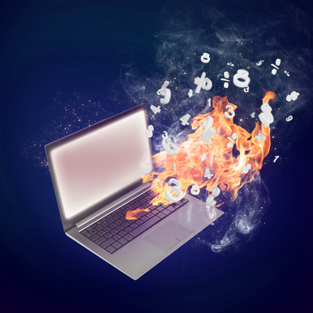 Conceptual image with laptop burning in flamesの写真素材
