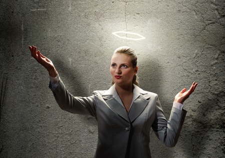 Young saint businesswoman with light above her headの写真素材