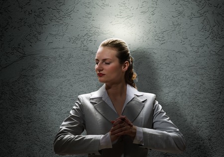 Young saint businesswoman with light above her headの写真素材