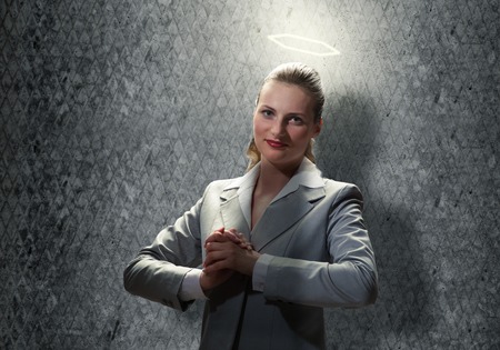 Young saint businesswoman with light above her headの写真素材