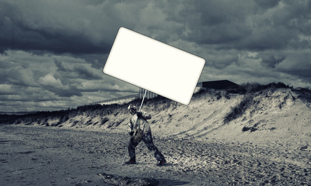 Stalker in gas mask with blank banner. Place for your text