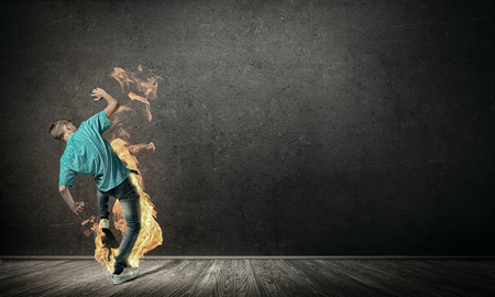 Skater boy riding on his skateboard burning in fireの写真素材